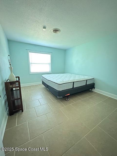 351 Taylor Ave Unit E5, Cape Canaveral, FL 32920 - bedroom with tile patterned flooring and a textured ceiling