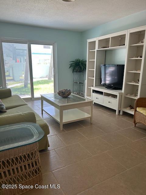351 Taylor Ave Unit E5, Cape Canaveral, FL 32920 - tiled living area with a textured ceiling