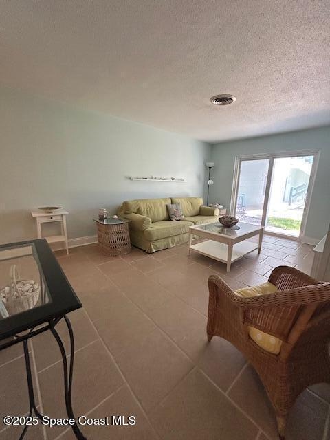 351 Taylor Ave Unit E5, Cape Canaveral, FL 32920 - living area featuring tile patterned flooring and a textured ceiling