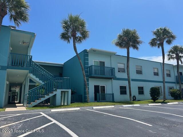 351 Taylor Ave Unit E5, Cape Canaveral, FL 32920 - view of property featuring stairway and uncovered parking