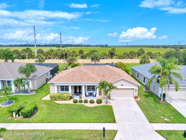 5337 Indigo Crossing Dr, Rockledge, FL 32955 - view of front of house featuring an attached garage, covered porch, driveway, and a front yard