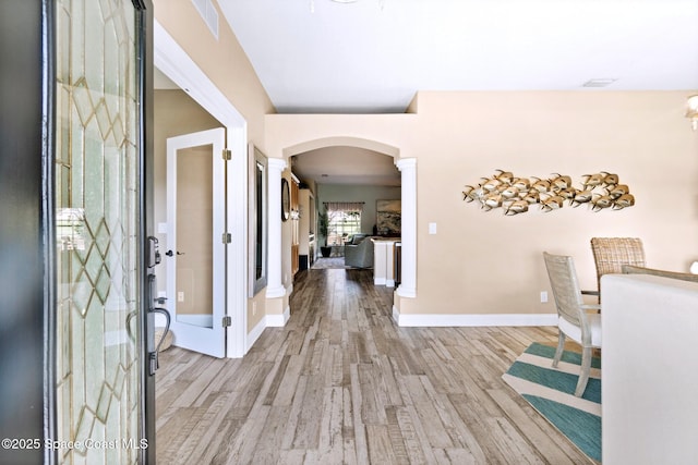 5337 Indigo Crossing Dr, Rockledge, FL 32955 - entryway featuring arched walkways, light wood-style floors, and decorative columns