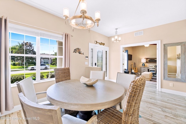 5337 Indigo Crossing Dr, Rockledge, FL 32955 - dining room with a chandelier, healthy amount of natural light, and light wood-type flooring
