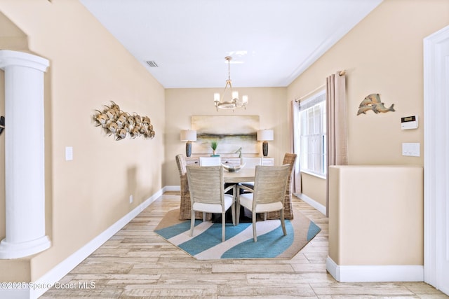 5337 Indigo Crossing Dr, Rockledge, FL 32955 - dining room with a chandelier, wood finished floors, and ornate columns