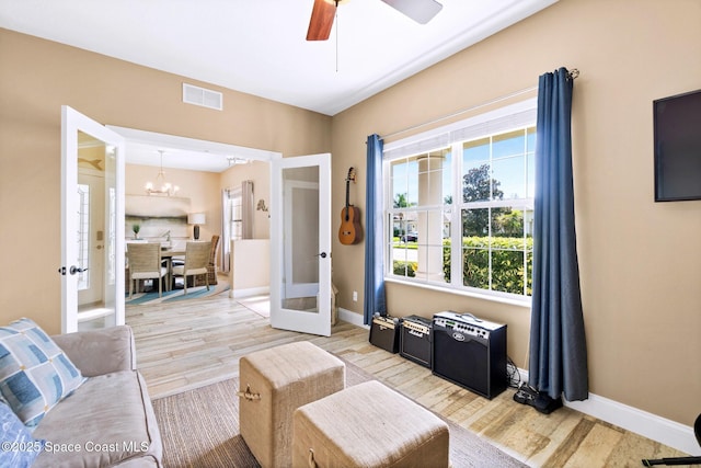 5337 Indigo Crossing Dr, Rockledge, FL 32955 - living area with french doors, wood finished floors, a chandelier, and ceiling fan
