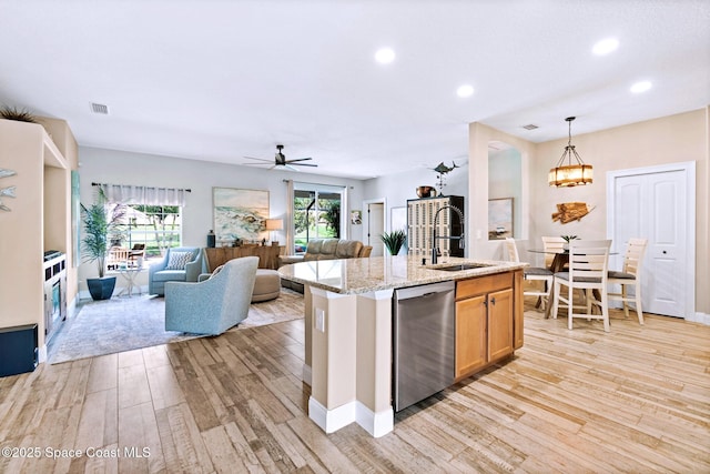 5337 Indigo Crossing Dr, Rockledge, FL 32955 - kitchen featuring dishwasher, light wood-style floors, open floor plan, recessed lighting, and light stone countertops