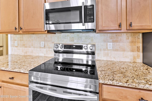 5337 Indigo Crossing Dr, Rockledge, FL 32955 - kitchen with appliances with stainless steel finishes, backsplash, and light stone counters