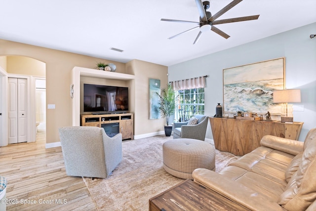 5337 Indigo Crossing Dr, Rockledge, FL 32955 - living area featuring a ceiling fan, arched walkways, and light wood-style flooring