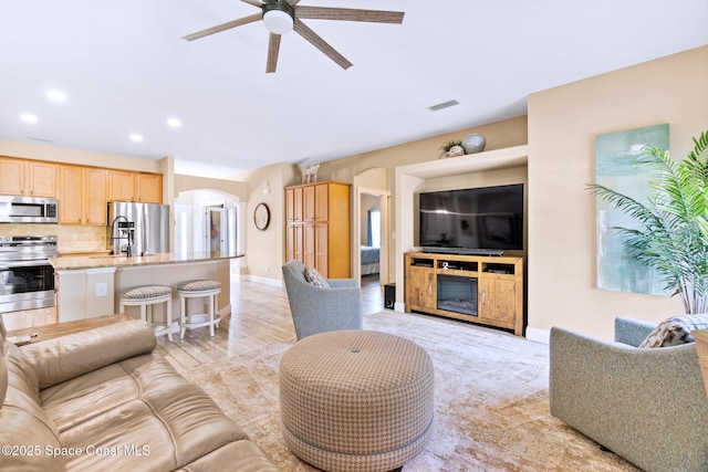 5337 Indigo Crossing Dr, Rockledge, FL 32955 - living area featuring arched walkways, ceiling fan, and recessed lighting
