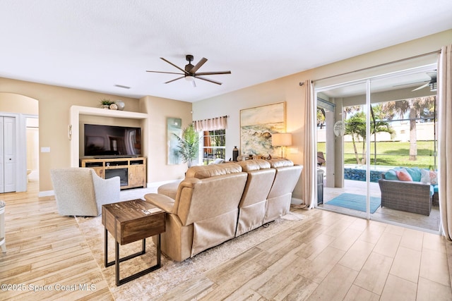 5337 Indigo Crossing Dr, Rockledge, FL 32955 - living room with ceiling fan, plenty of natural light, light wood-type flooring, and a textured ceiling