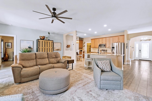 5337 Indigo Crossing Dr, Rockledge, FL 32955 - living area featuring arched walkways, a ceiling fan, light wood finished floors, recessed lighting, and a chandelier