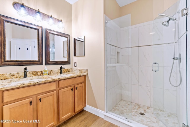 5337 Indigo Crossing Dr, Rockledge, FL 32955 - full bath featuring a stall shower, double vanity, and wood finished floors