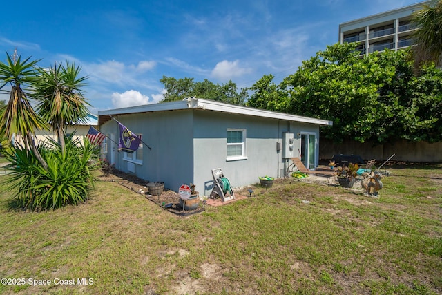 113 Surf Dr, Cocoa Beach, FL 32931 - rear view of house with stucco siding