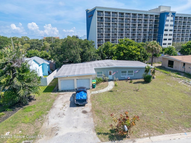 113 Surf Dr, Cocoa Beach, FL 32931 - view of front of house featuring driveway, a garage, and stucco siding