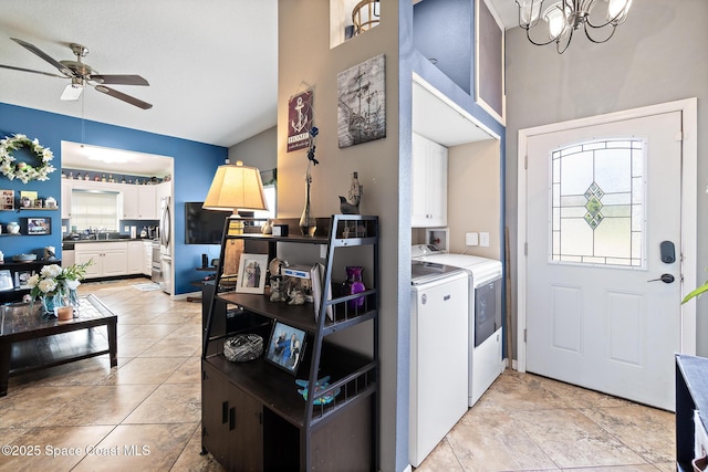 113 Surf Dr, Cocoa Beach, FL 32931 - laundry room with cabinet space, separate washer and dryer, ceiling fan, a chandelier, and a towering ceiling