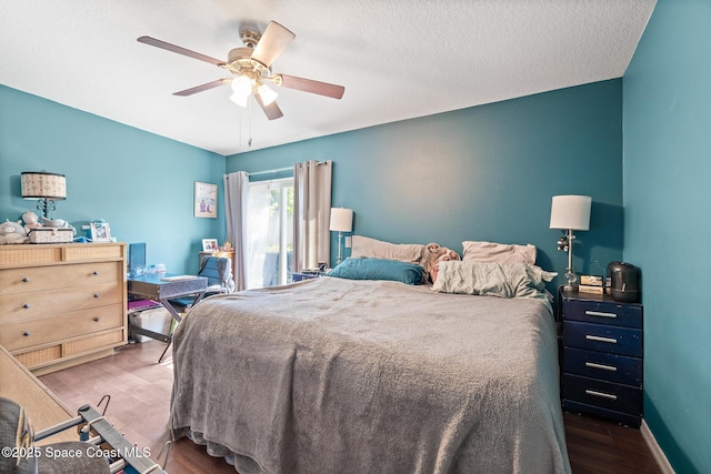 113 Surf Dr, Cocoa Beach, FL 32931 - bedroom featuring wood finished floors, a ceiling fan, and a textured ceiling