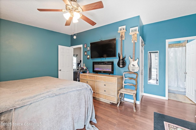 113 Surf Dr, Cocoa Beach, FL 32931 - bedroom featuring wood finished floors and ceiling fan
