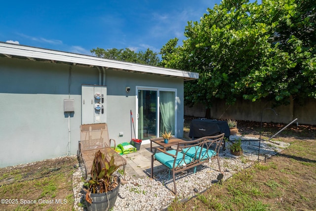 113 Surf Dr, Cocoa Beach, FL 32931 - back of property featuring a patio and stucco siding
