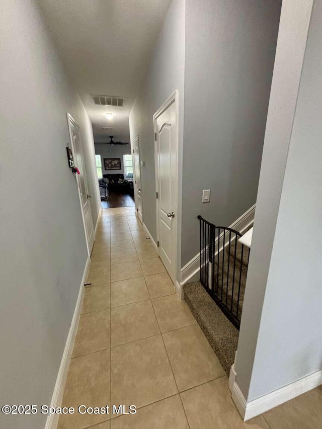 3725 Aria Dr, Melbourne, FL 32904 - hallway with light tile patterned floors and stairway