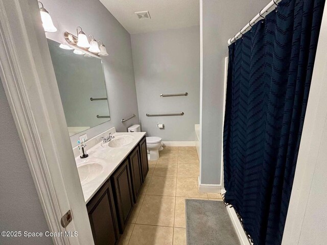 3725 Aria Dr, Melbourne, FL 32904 - full bath with tile patterned floors, double vanity, and a shower with shower curtain