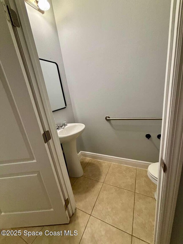 3725 Aria Dr, Melbourne, FL 32904 - half bathroom with toilet and tile patterned flooring