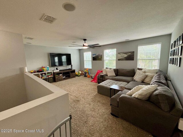 3725 Aria Dr, Melbourne, FL 32904 - carpeted living room featuring a textured ceiling and ceiling fan