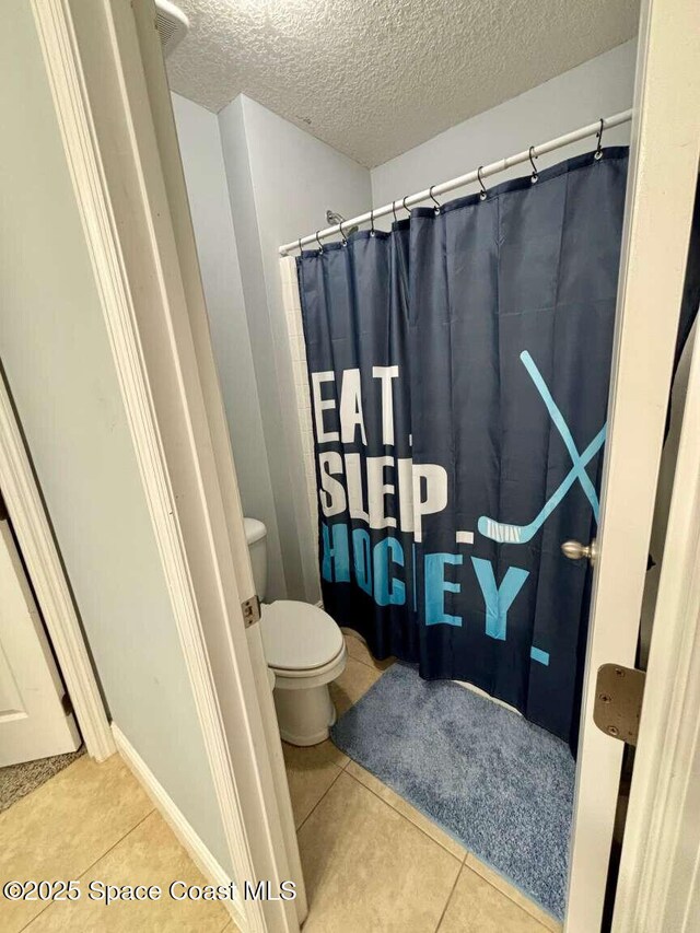 3725 Aria Dr, Melbourne, FL 32904 - full bathroom with tile patterned floors, a textured ceiling, and curtained shower