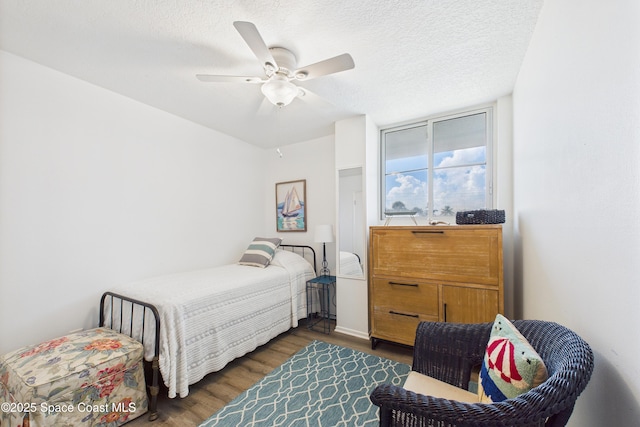 3190 N Atlantic Ave Unit 220, Cocoa Beach, FL 32931 - bedroom featuring wood finished floors, a ceiling fan, and a textured ceiling