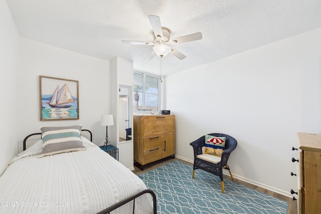 3190 N Atlantic Ave Unit 220, Cocoa Beach, FL 32931 - bedroom with a textured ceiling, ceiling fan, and dark wood-type flooring