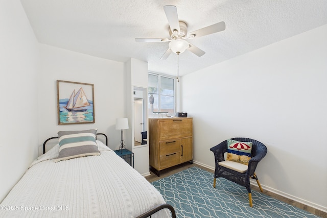 3190 N Atlantic Ave Unit 220, Cocoa Beach, FL 32931 - bedroom with a textured ceiling, a ceiling fan, and dark wood-style floors