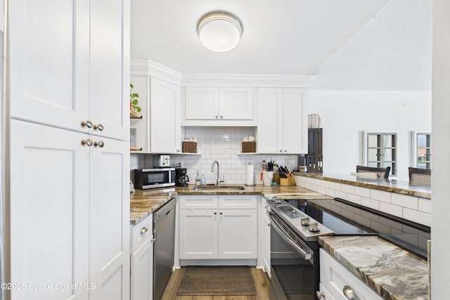 3190 N Atlantic Ave Unit 220, Cocoa Beach, FL 32931 - kitchen with appliances with stainless steel finishes, white cabinets, and backsplash