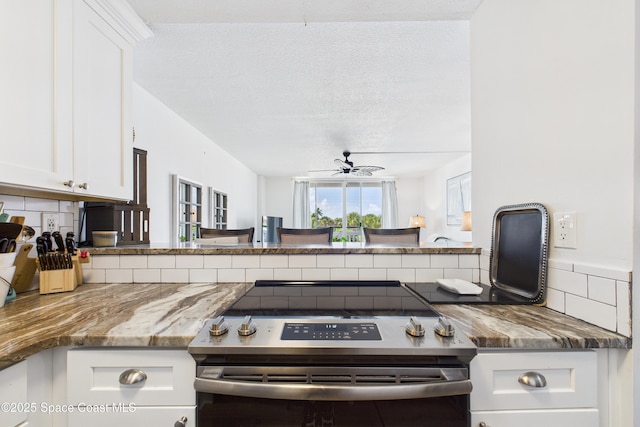 3190 N Atlantic Ave Unit 220, Cocoa Beach, FL 32931 - kitchen featuring stainless steel range with electric cooktop, tasteful backsplash, ceiling fan, white cabinetry, and a textured ceiling