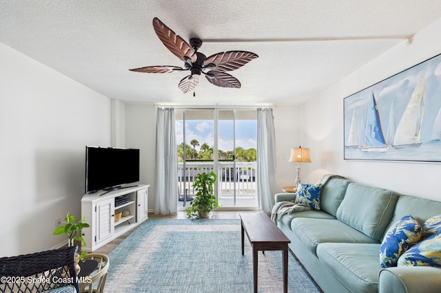 3190 N Atlantic Ave Unit 220, Cocoa Beach, FL 32931 - living area featuring wood finished floors, a textured ceiling, and a ceiling fan