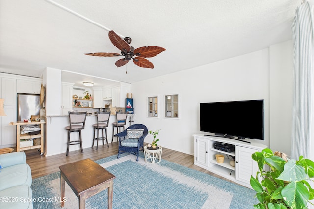 3190 N Atlantic Ave Unit 220, Cocoa Beach, FL 32931 - living room with light wood-style floors and ceiling fan