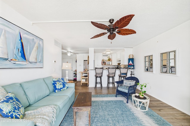 3190 N Atlantic Ave Unit 220, Cocoa Beach, FL 32931 - living area featuring a ceiling fan and wood finished floors