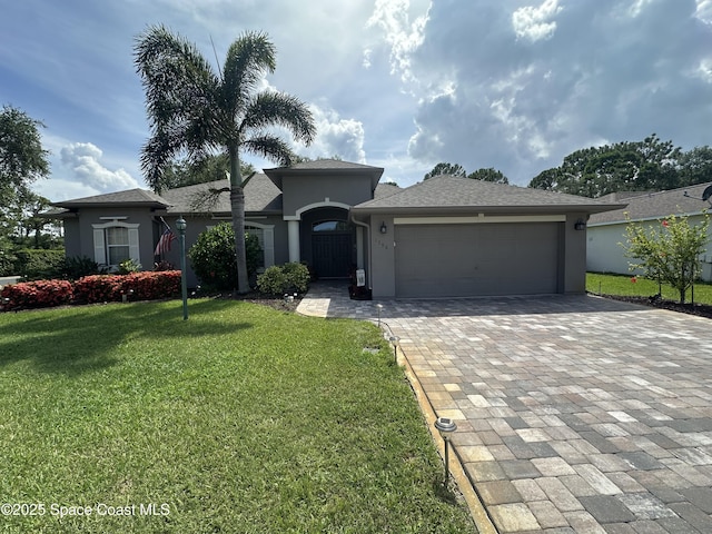 1796 Windbrook Dr SE, Palm Bay, FL 32909 - single story home with stucco siding, decorative driveway, a garage, and a front lawn