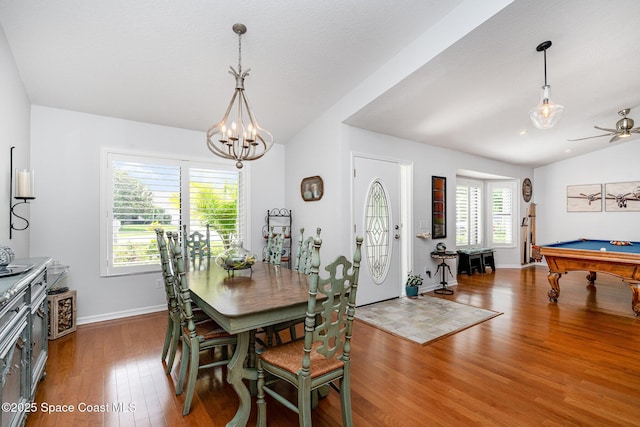 1453 Goldrush Ave, Melbourne, FL 32940 - dining room with lofted ceiling, wood finished floors, healthy amount of natural light, pool table, and a chandelier