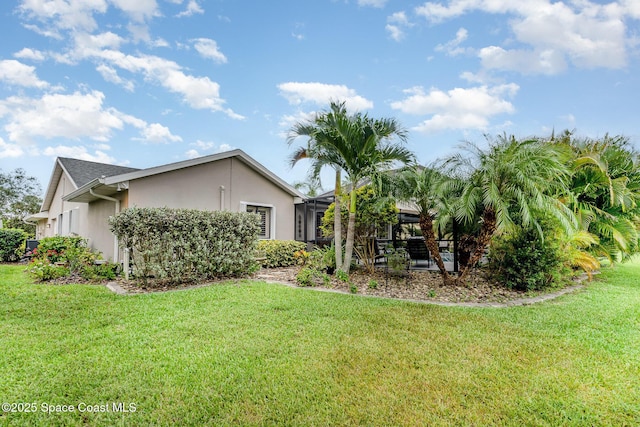1453 Goldrush Ave, Melbourne, FL 32940 - back of house featuring stucco siding and a lawn