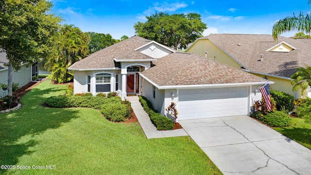 4490 Portage Trl, Melbourne, FL 32940 - view of front of home featuring an attached garage, a front lawn, stucco siding, concrete driveway, and roof with shingles