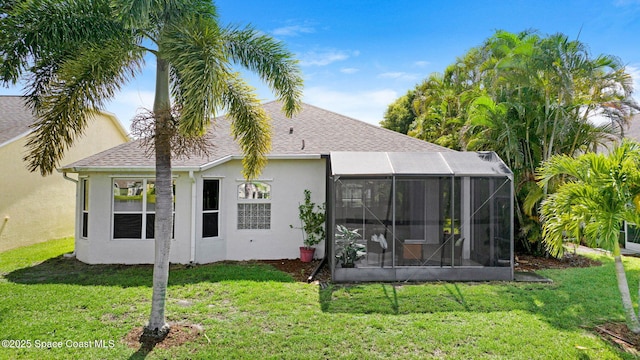 4490 Portage Trl, Melbourne, FL 32940 - back of house featuring stucco siding, a yard, a sunroom, and a shingled roof