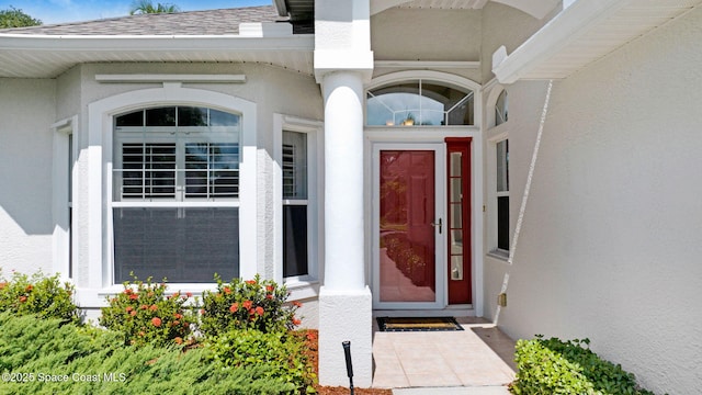 4490 Portage Trl, Melbourne, FL 32940 - entrance to property featuring stucco siding and a shingled roof