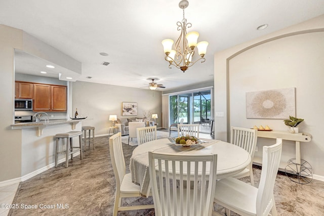4490 Portage Trl, Melbourne, FL 32940 - dining room featuring a ceiling fan, recessed lighting, arched walkways, and a chandelier