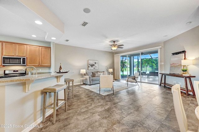 4490 Portage Trl, Melbourne, FL 32940 - living area featuring a ceiling fan, recessed lighting, and stone finish flooring
