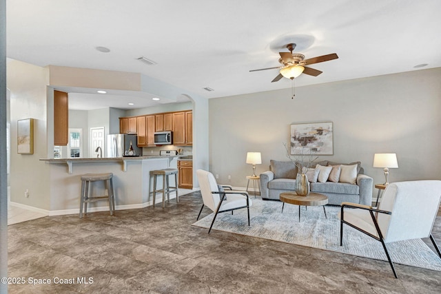 4490 Portage Trl, Melbourne, FL 32940 - living area featuring a ceiling fan and arched walkways