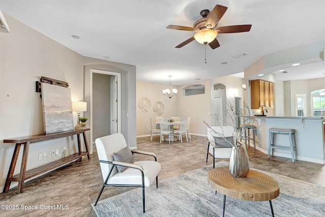 4490 Portage Trl, Melbourne, FL 32940 - living room with ceiling fan, a chandelier, and arched walkways