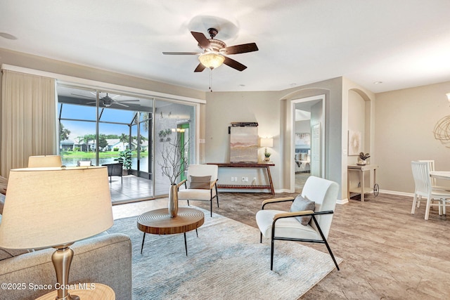4490 Portage Trl, Melbourne, FL 32940 - living room featuring a ceiling fan and arched walkways