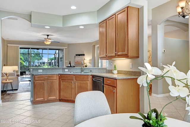 4490 Portage Trl, Melbourne, FL 32940 - kitchen featuring open floor plan, a peninsula, stainless steel dishwasher, light tile patterned floors, and recessed lighting