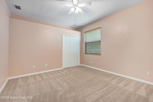 4490 Portage Trl, Melbourne, FL 32940 - unfurnished room with light carpet, a ceiling fan, and a textured ceiling