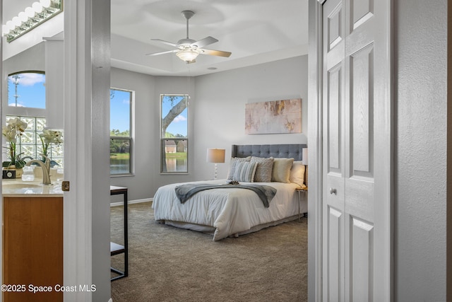 4490 Portage Trl, Melbourne, FL 32940 - carpeted bedroom with a sink and a ceiling fan