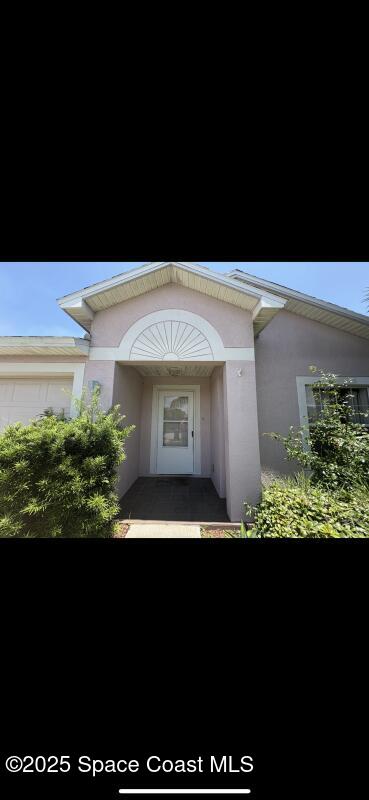 4094 Wilkes Dr, Melbourne, FL 32901 - view of exterior entry with stucco siding